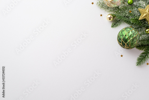 New Year concept. Top view photo of pine branch with stylish baubles gold star ornament and shiny confetti on isolated white background with copyspace