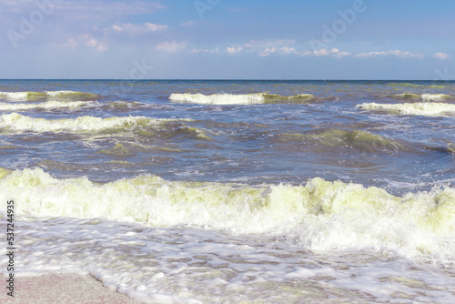 The Black Sea in sunny weather. Surf on the beach, waves,sandy shore