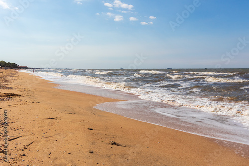 The Black Sea in sunny weather. Surf on the beach, waves,sandy shore
