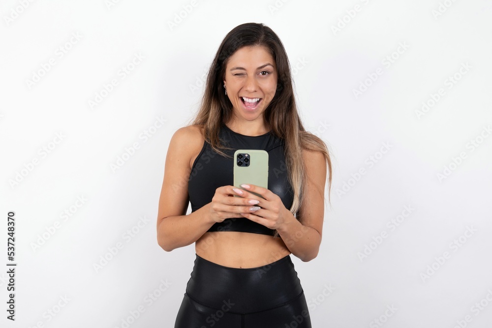 young beautiful woman wearing sportswear over white background taking a selfie celebrating success young beautiful woman wearing sportswear over white background taking a selfie celebrating success