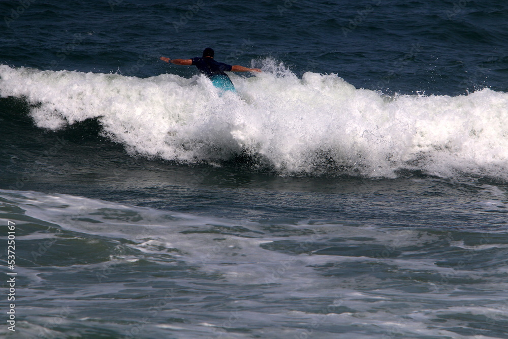 Surfing on high waves on the Mediterranean Sea in northern Israel. Surfing on high waves on the Mediterranean Sea in northern Israel.