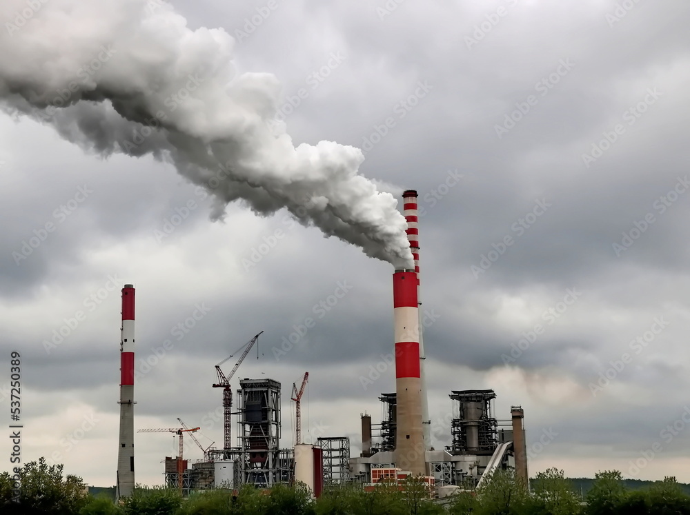 Coal power plant high pipes with black smoke moving up polluting atmosphere Coal power plant high pipes with black smoke moving up polluting atmosphere