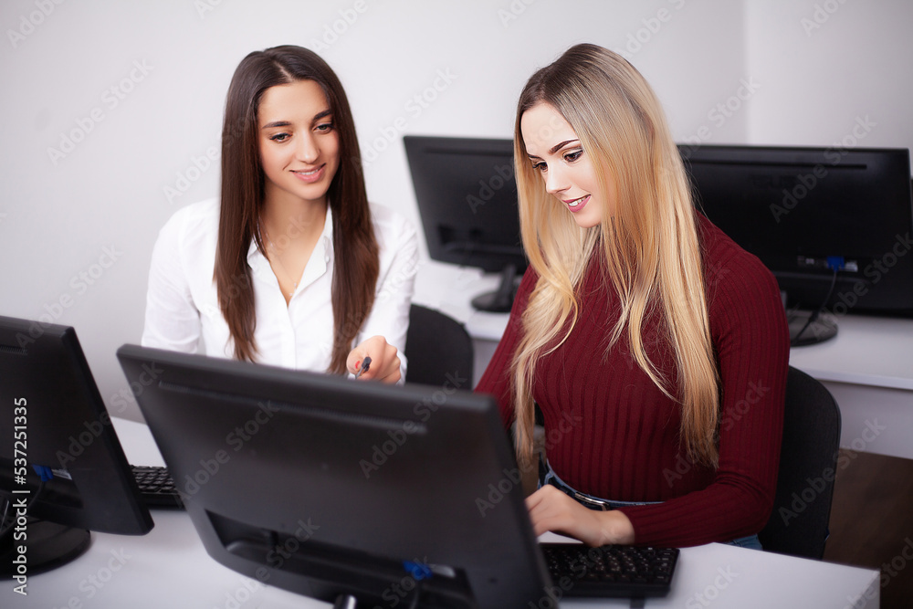 Two female colleagues in office working together Two female colleagues in office working together