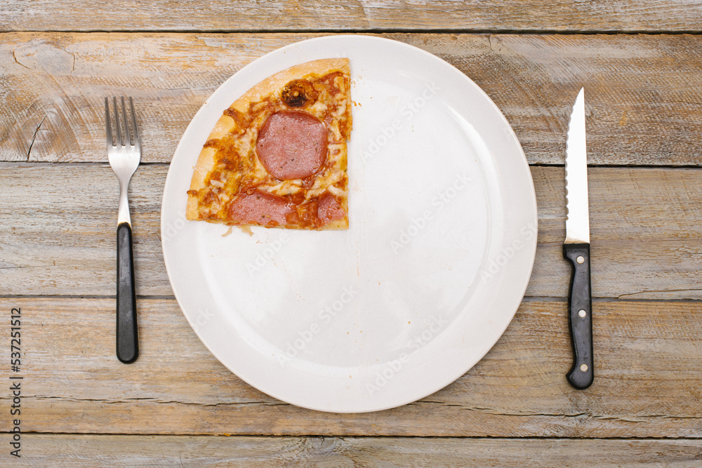 One quarter - Pizza pieces series as illustration of division in maths on wood table