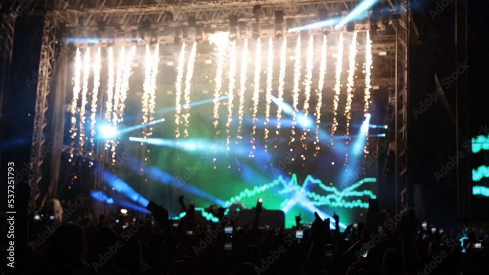 Seamless loop stage lights with golden fireworks falling on night concert 