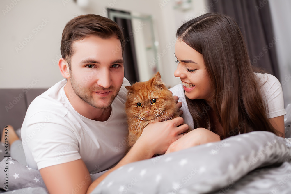 Happy sensual young couple lying in bed together Happy sensual young couple lying in bed together