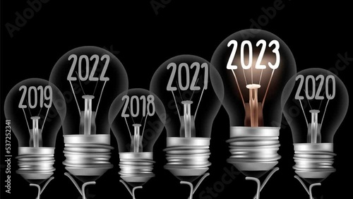 Shining light bulb with New Year 2023 and group of dark light bulbs in a row going from 2018 to 2022 isolated on black background. High quality 4k video.