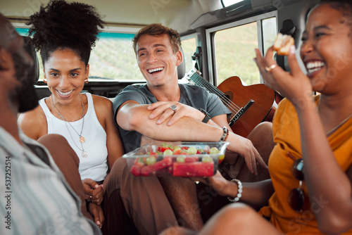 Travel, road trip and friends in car with food while they laugh and relax on summer vacation. Interracial friendship with happy holiday people on picnic break together with fruit in vehicle.