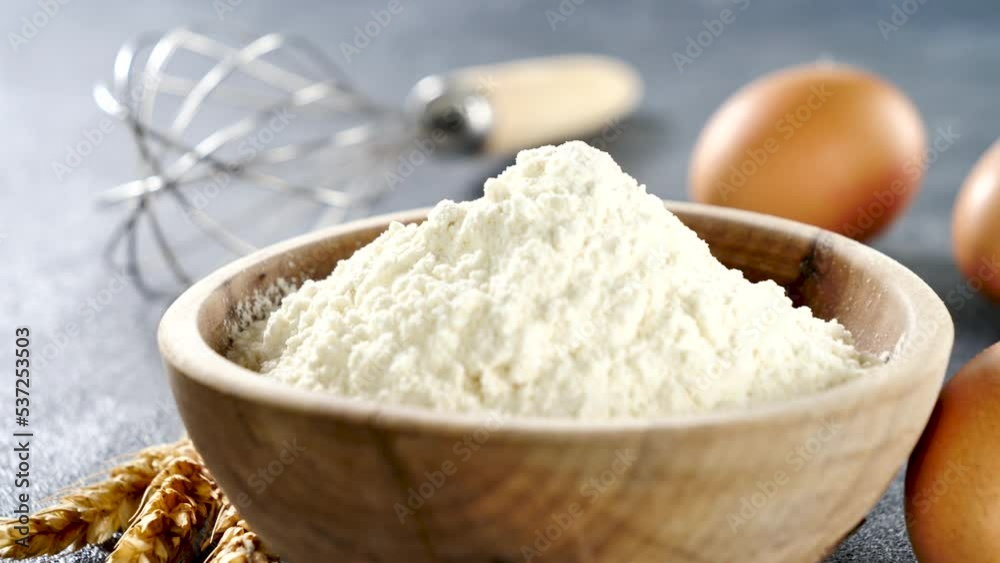 baking ingredient ( bowl of flour, egg and whisk) baking ingredient ( bowl of flour, egg and whisk)