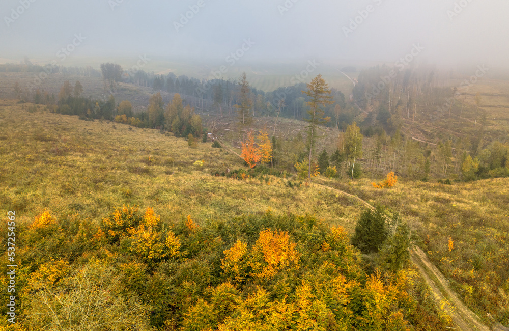 Aerial view of autumn sunrise countryside, traditional fall landscape with rising sun in Central Europe. Foggy and misty sunrise. Frozen landscape from bird eye. Czech Republic,Vysocina highland