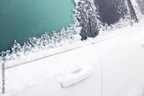 Snow and ice covering car in winter, UK