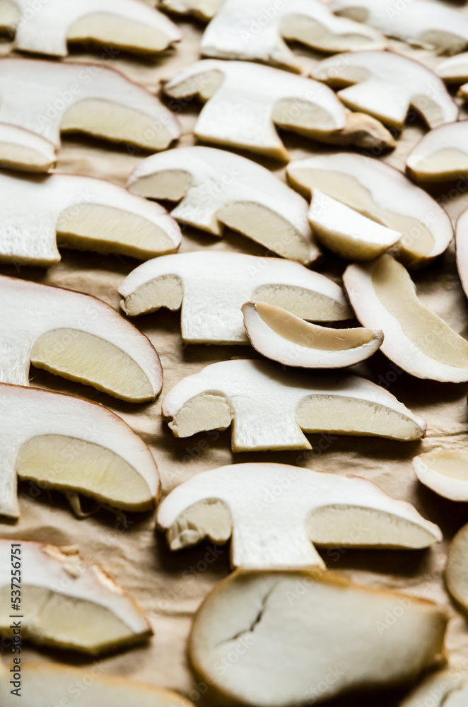 Raw Boletus edulis, penny bun, cep, porcino or porcini mushroom, top view of sliced edible mushrooms in the kitchen