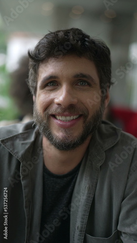 Portrait of a young man smiling at camera closeup face. Happy 30s person in Vertical Video SS