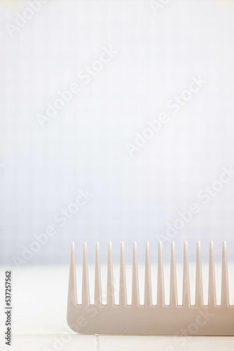 The beauty of a close-up hair comb on a white isolation background. Vertical orientation.
