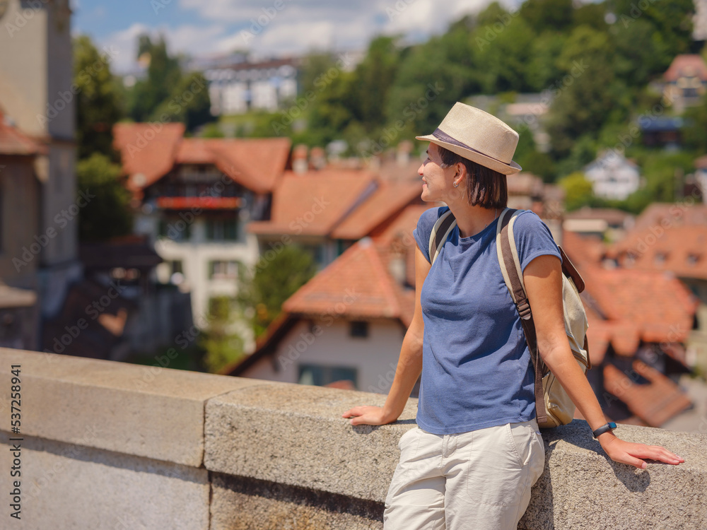 having great vacation in Switzerland, BErn. Lady visiting tourist attractions and landmarks. Woman tourist on top of cityscape view to old town of Bern having great vacation in Switzerland, BErn. Lady visiting tourist attractions and landmarks. Woman tourist on top of cityscape view to old town of Bern
