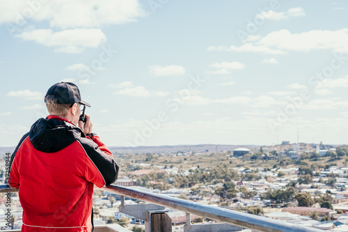 Man talking into two way radio.