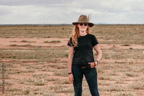 Woman wearing a hat standing in the outback. photo