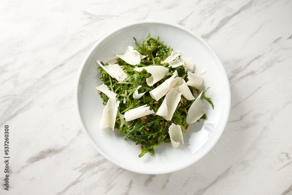 Rocket salad with sliced parmesan cheese Rocket salad with sliced parmesan cheese