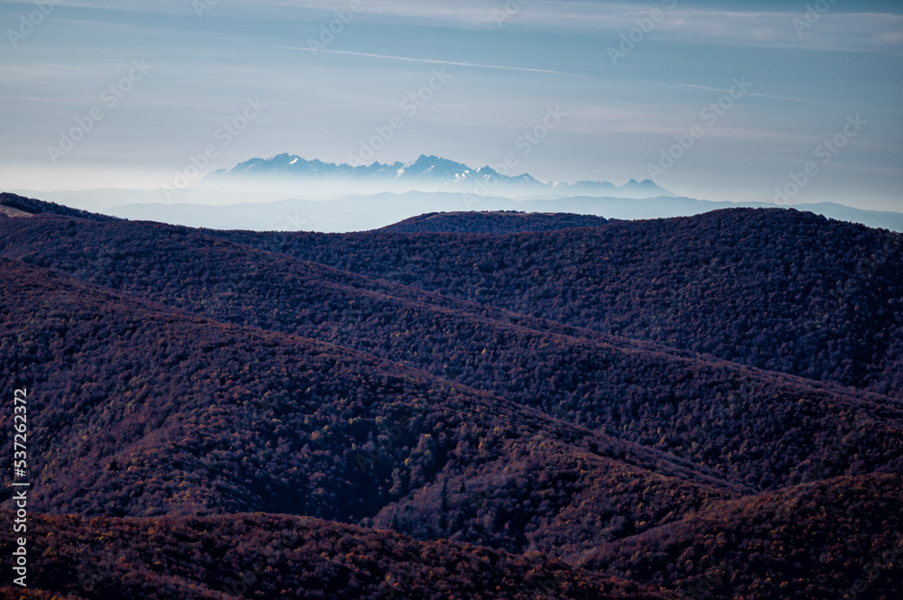 The Tatra Mountains seen from the Bieszczady Mountains. The temperature inversion and long distant visibility.