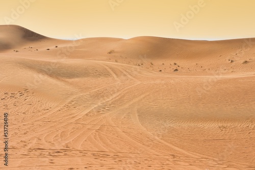 Landscape photo of desert and sand dune under the golden hour sunset sky in Dubai  UAE