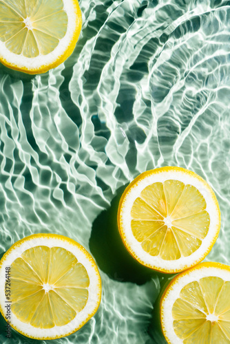 Transparent fresh exhilarant wave water with flecks background, lemon citrus slices. Summer freshness, healthy eating beach travel drinks concept. Vitaminic moisturizing care. Vertical. Copy space