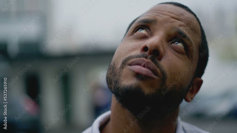 Portrait of a sad pensive black man. Thoughtful depressed African American young person face Portrait of a sad pensive black man. Thoughtful depressed African American young person face