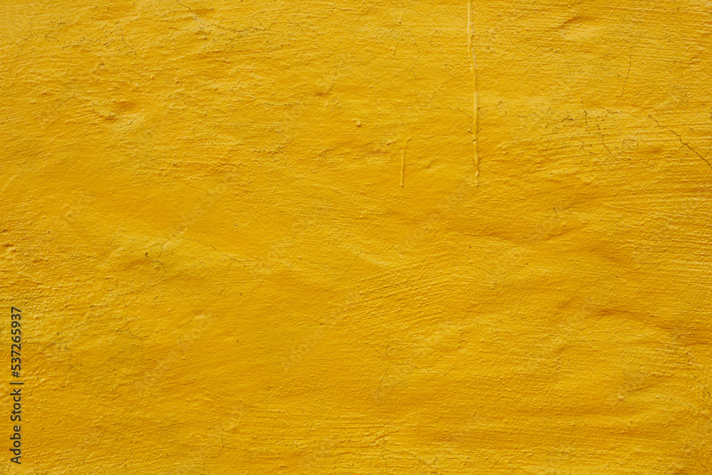 Fototapeta premium rough plaster wall painted bright yellow background