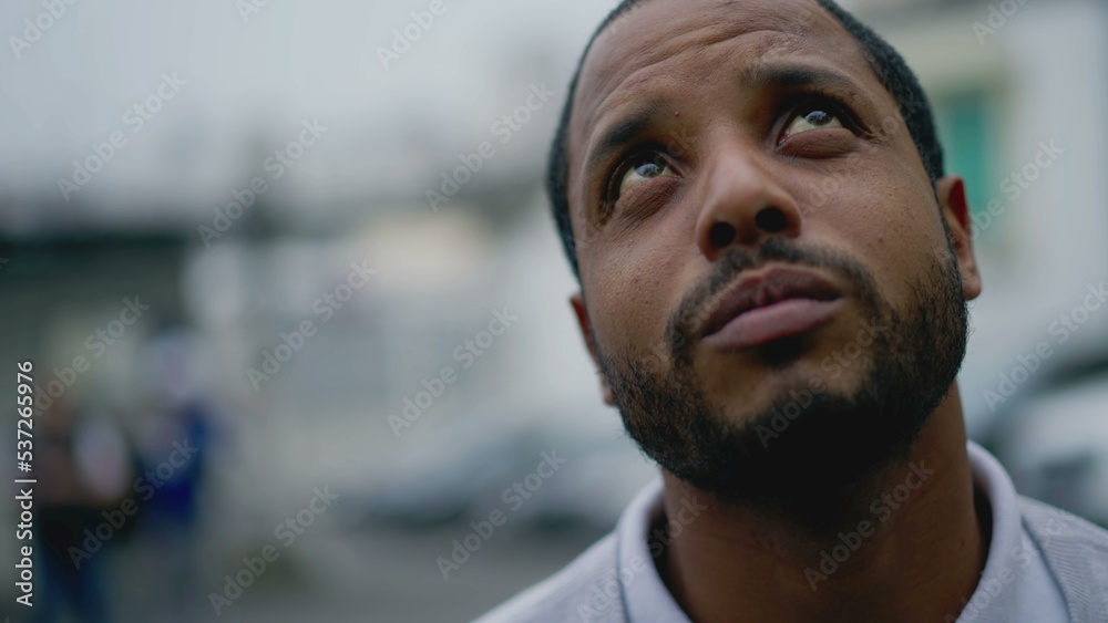 Portrait of a sad pensive black man. Thoughtful depressed African American young person face Portrait of a sad pensive black man. Thoughtful depressed African American young person face