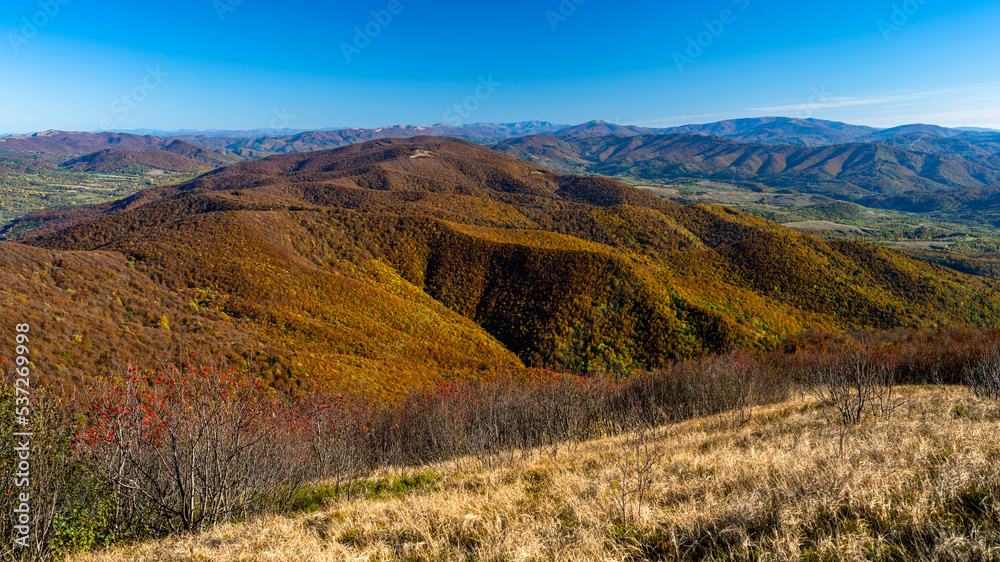Ukrainian part of the Bieszczady Mountains seen from the Mount Wielka Rawka in the Bieszczady National Park. Colorful autumn mountain landscape