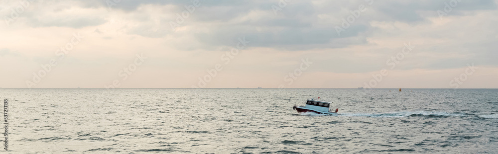 modern white ship sailing in wavy sea on bosporus during sunset, banner.