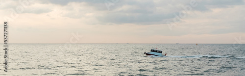 modern white ship sailing in wavy sea on bosporus during sunset, banner. © LIGHTFIELD STUDIOS
