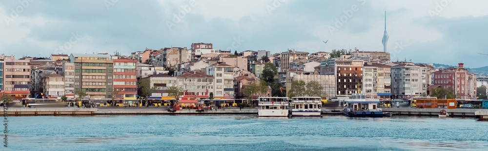 different ships and boats on pier near buildings in istanbul, banner.
