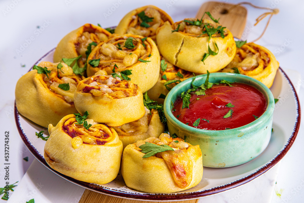 Homemade twisted Pizza rolls with tomato sauce, tomato, and cheese, trendy finger food eating pizza bites Homemade twisted Pizza rolls with tomato sauce, tomato, and cheese, trendy finger food eating pizza bites