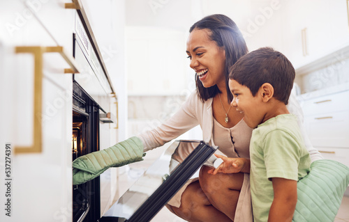 Mother, child and baking in oven learning to make biscuits, cookies or cake in home kitchen. Care, support or love of happy parent bonding, cooking or teaching boy to bake dessert on stove together