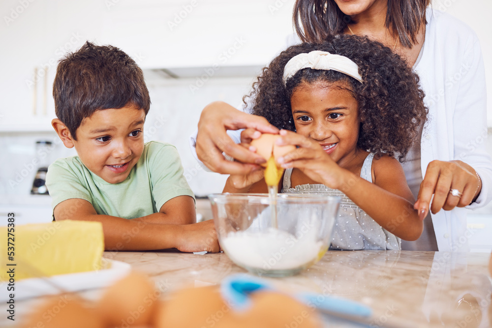 Cooking, food and children with a girl and boy baking or learning in the kitchen of their home together with mom. Kids, egg and bake with a mother teaching a brother and sister how to make cake mix Cooking, food and children with a girl and boy baking or learning in the kitchen of their home together with mom. Kids, egg and bake with a mother teaching a brother and sister how to make cake mix