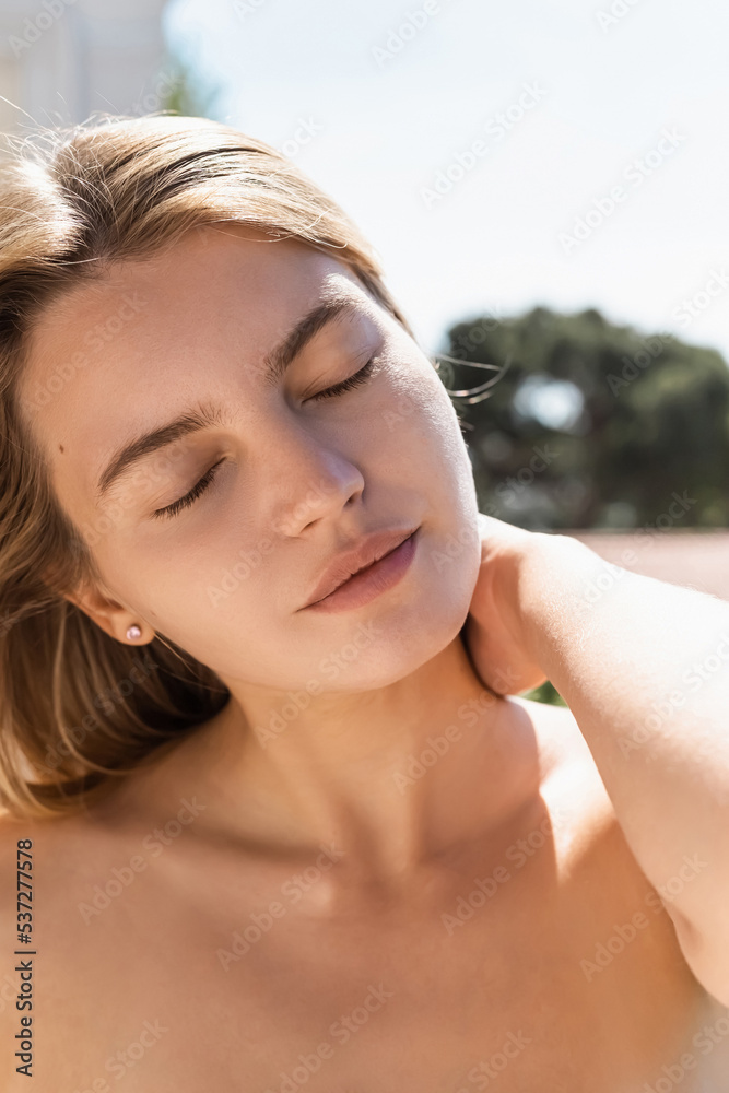 portrait of blonde and young woman with closed eyes during vacation. portrait of blonde and young woman with closed eyes during vacation.