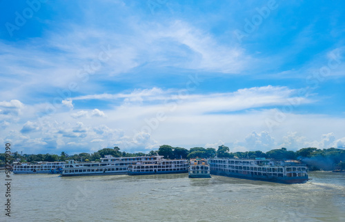 Beautiful landscape of Chandpur river port in Bangladesh. Ferry boats on the river with a cloudy sky background. Panoramic view. photo