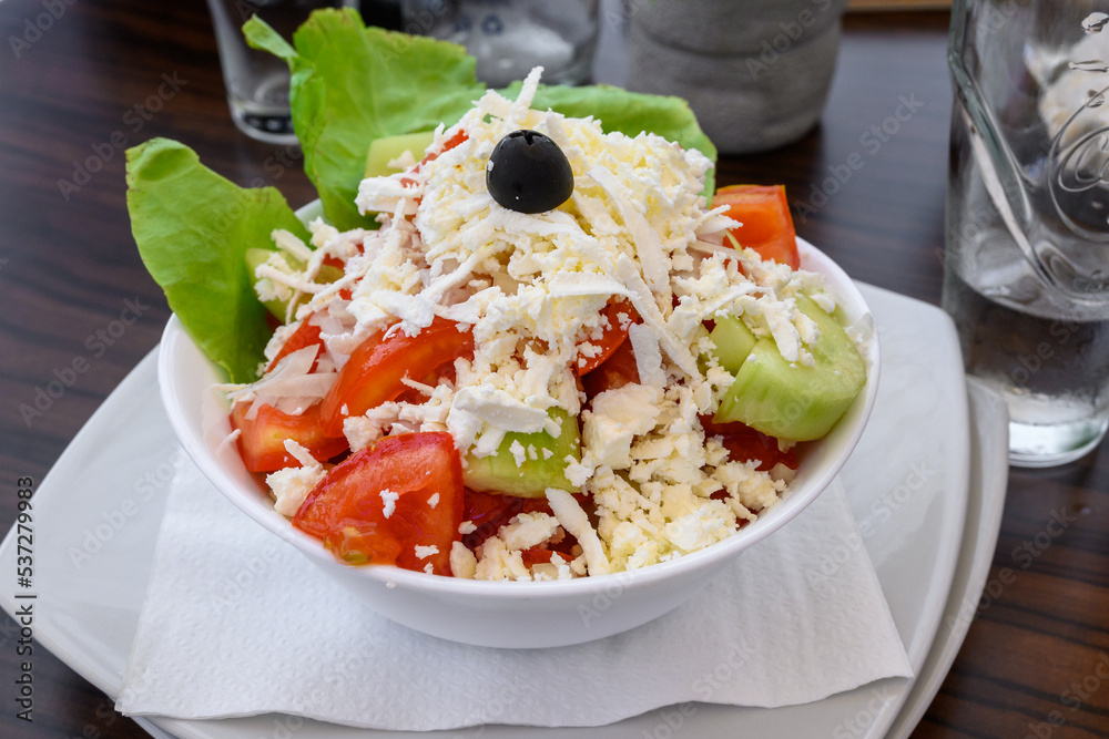Shopska salad, one of the most popular salads in the menu of the Montenegrin restaurants. Mix of cucumbers, tomatoes, peppers, onions, cheese and olive oil.