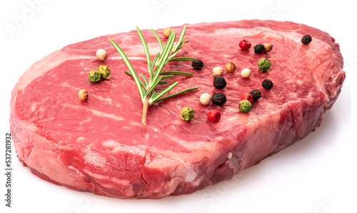 Ribeye steak with peppercorn and rosemary isolated on white background. Closeup.