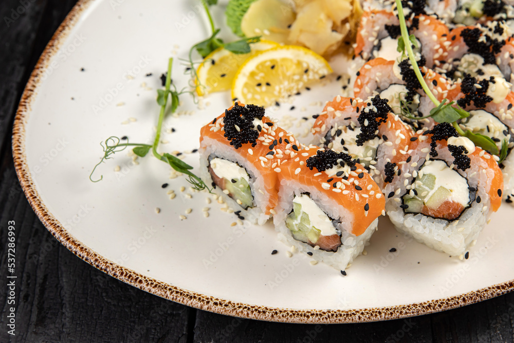 sushi roll with wasabi and sesame seeds on the plate. delicious food, close-up sushi roll with wasabi and sesame seeds on the plate. delicious food, close-up