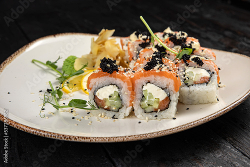 sushi roll with wasabi and sesame seeds on the plate. delicious food, close-up