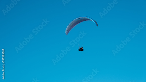 paraglider in a blue sky