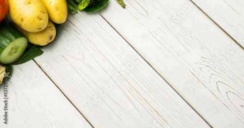 High angle view of fresh raw vegetables over wooden table, copy space