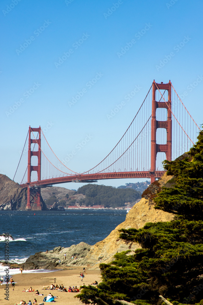 Fototapeta premium Famous Golden Gate bridge in San Francisco with a clear blue sky and wavy sea