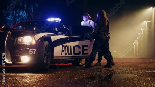 Two Police Officers Arrest Suspect, Put Him in Patrol Сar. Officers of the Law Handcuff Dangerous Criminal on Dark City Street. Officers of the Law Arresting Felon, Fight Crime. Cinematic Slow Motion