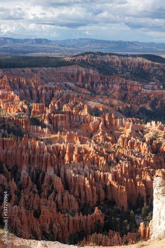 Bryce Canyon - red spiky rocks in Bryce canyon in Utah. Bryce canyon amphitheater overlook with fascinating red and orange rocks in the golden hour