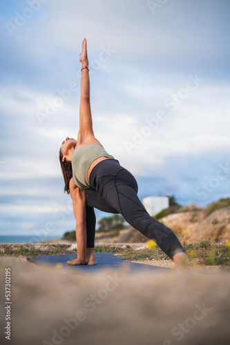 Woman practicing yoga in the triangle position.