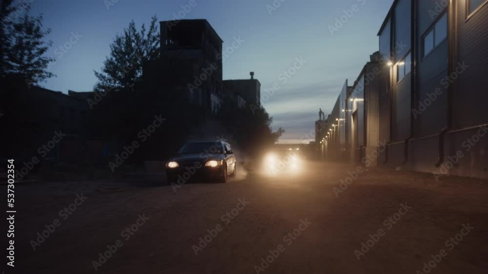Highway Traffic Patrol Car In Pursuit of Criminal Vehicle. Police Officers in Squad Car Chase Suspect on Road. Criminal Crashes into Boxes. Cinematic Industrial Area. Action Scene in Slow Motion Highway Traffic Patrol Car In Pursuit of Criminal Vehicle. Police Officers in Squad Car Chase Suspect on Road. Criminal Crashes into Boxes. Cinematic Industrial Area. Action Scene in Slow Motion