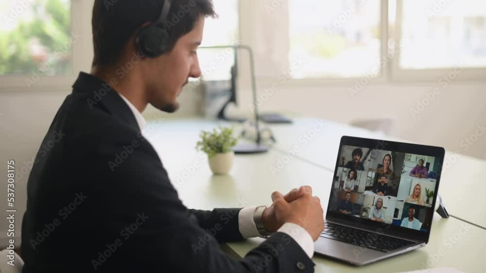 Morning meeting on the distance, latin businessman using laptop for video connection with group of diverse colleagues, freelancer guy making video call Morning meeting on the distance, latin businessman using laptop for video connection with group of diverse colleagues, freelancer guy making video call