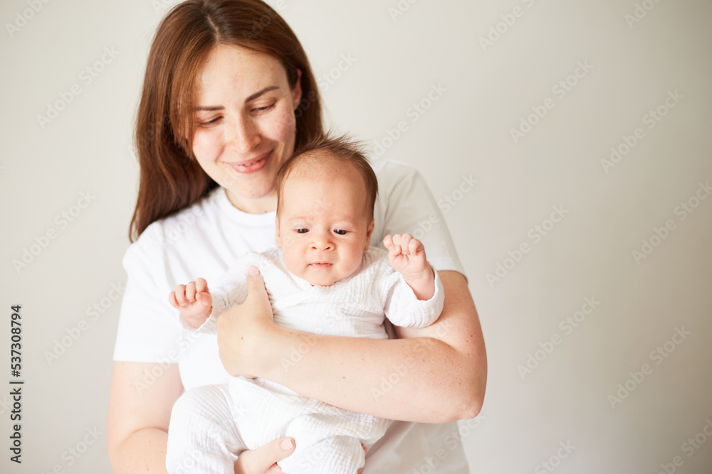 Mother holding her newborn baby. Home portrait of newborn baby and mother. Enjoying time together Mother holding her newborn baby. Home portrait of newborn baby and mother. Enjoying time together